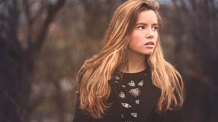 Beautiful Sad Girl in Autumn Forest